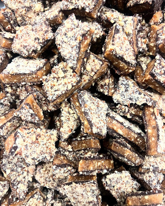 close up of dark chocolate coated toffee with almnonds