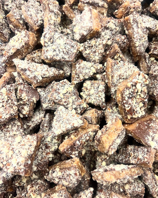 close up of milk chocolate coated toffee covered in almonds